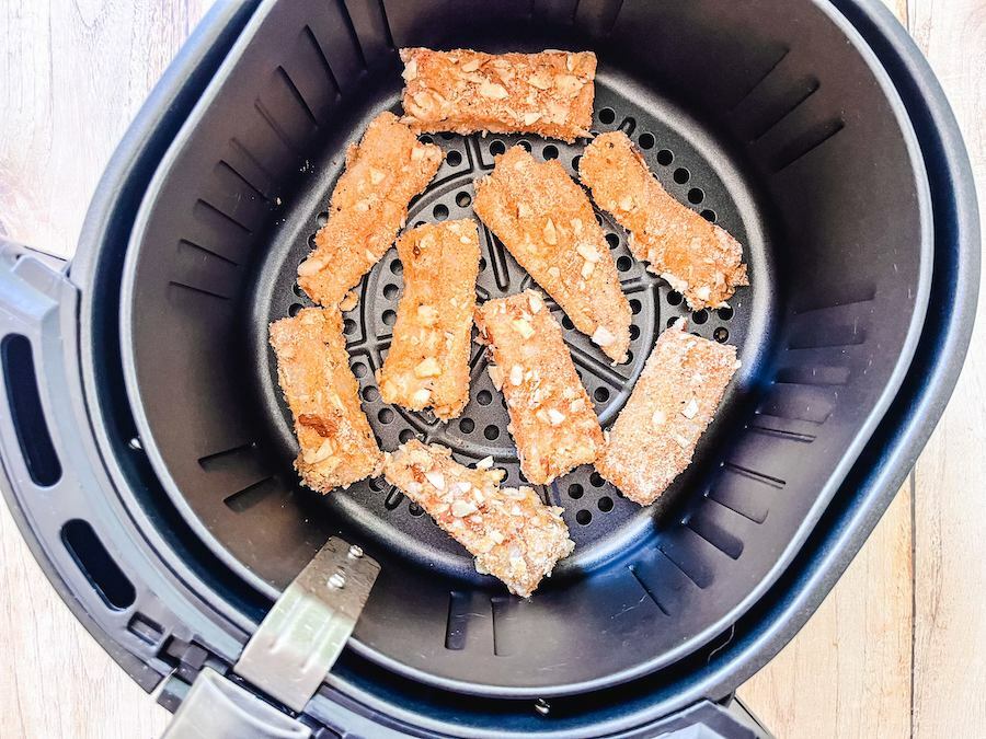 Fish sticks in air fryer tray.