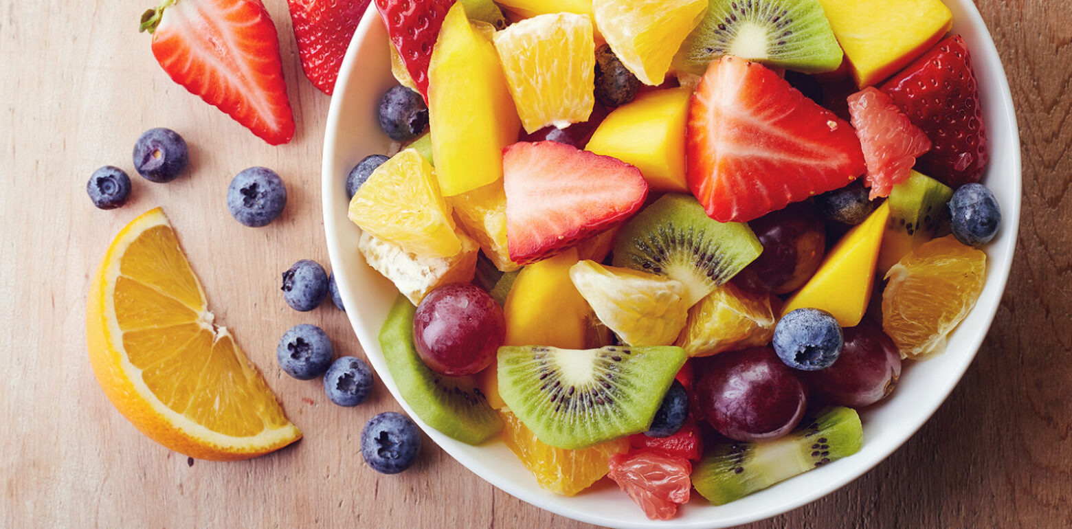 A bowl of colorful, chopped fresh fruits.