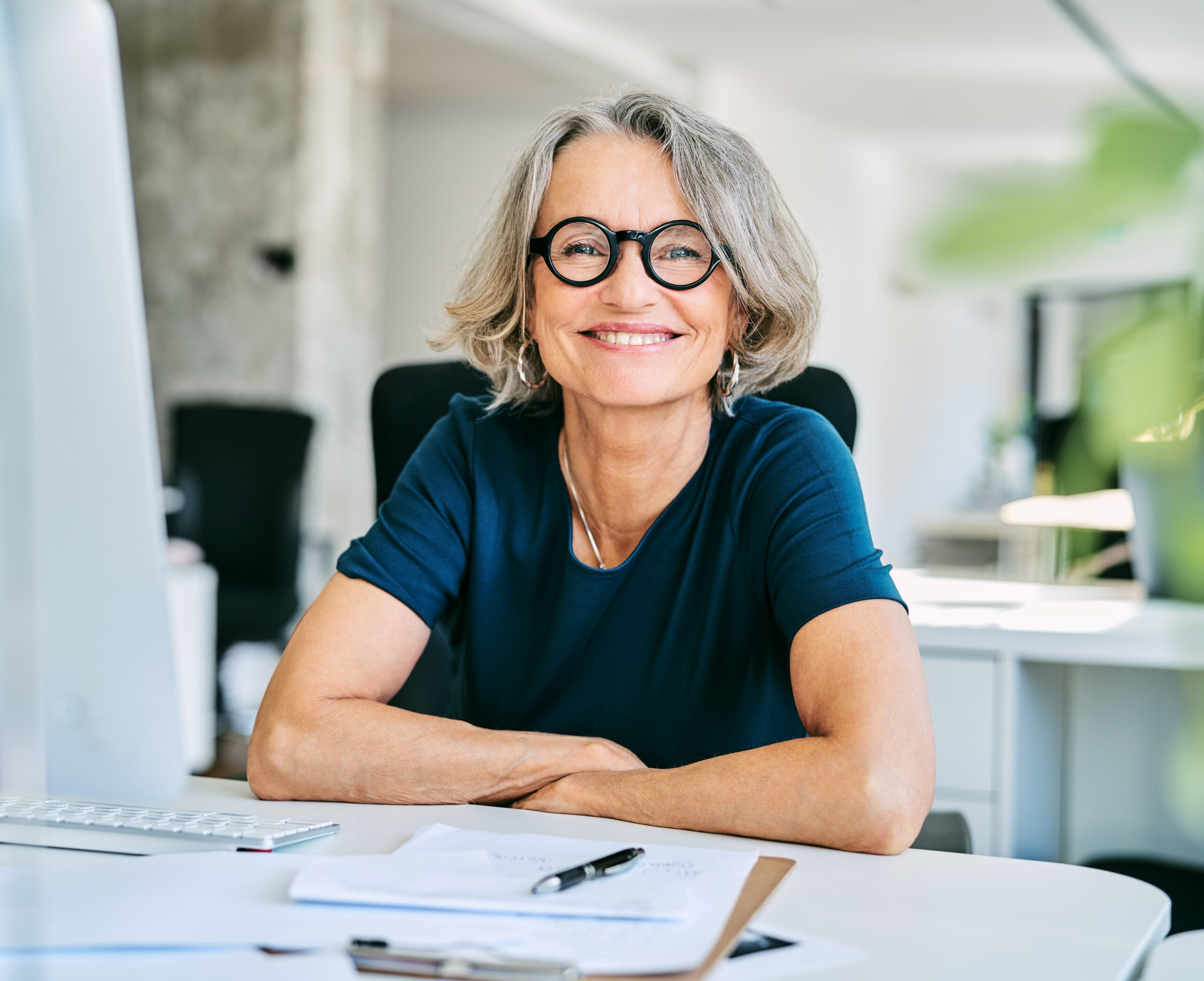 Smiling businesswoman at desk in office