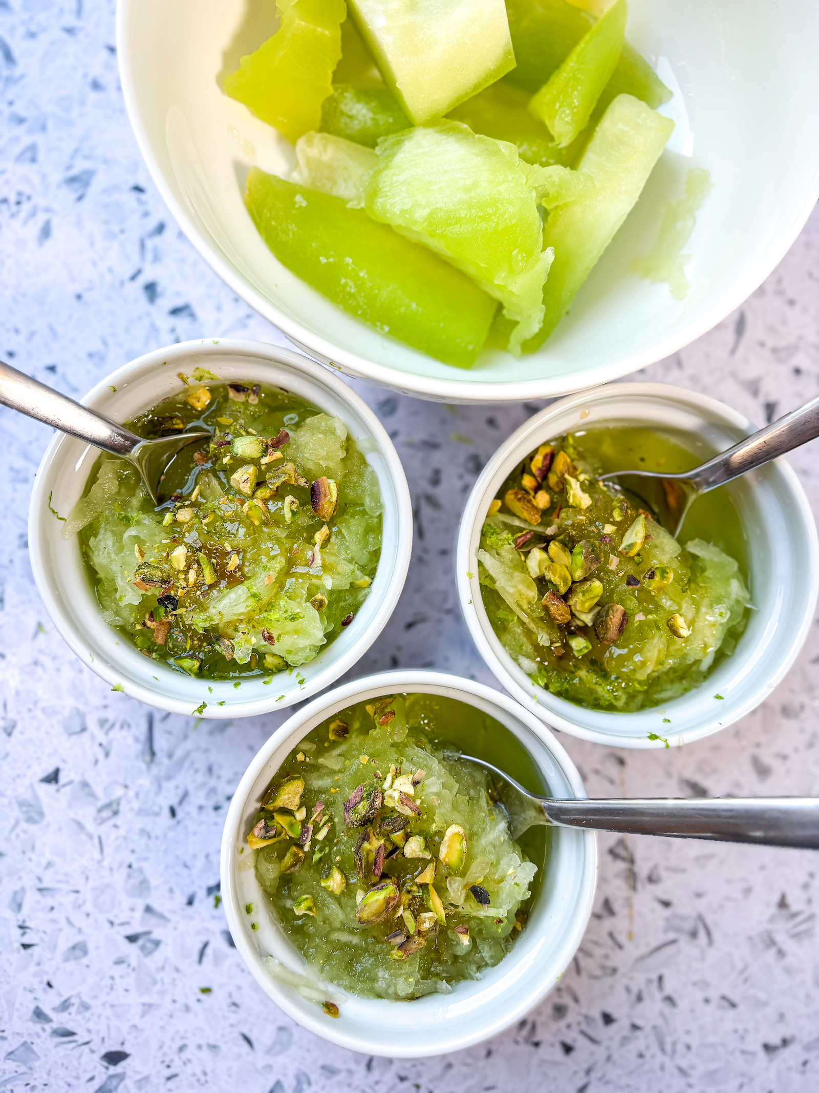 Above final photo of honeydew granita with pistachios and honey toppings