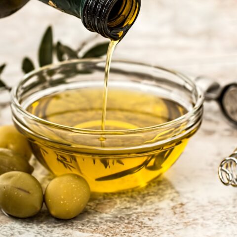 olives and olive oil being poured