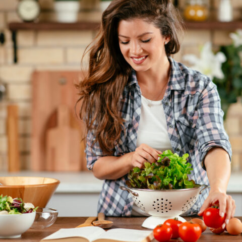 Woman making a salad in her kitchen