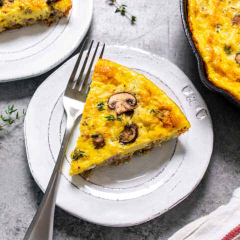 Protein packed mushroom frittata with fresh thyme plated with a fork.