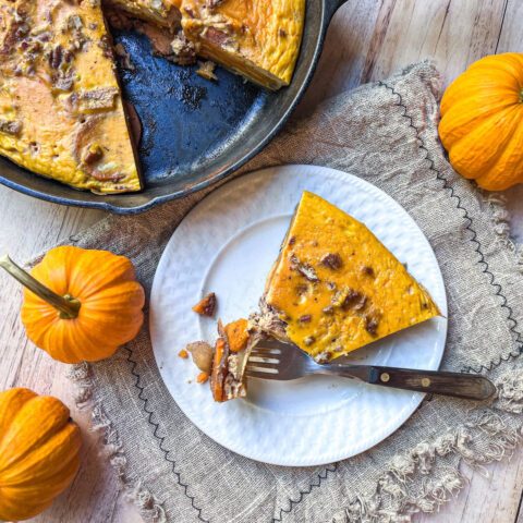 A slice of Pumpkin Apple Breakfast Bake lies on a plate