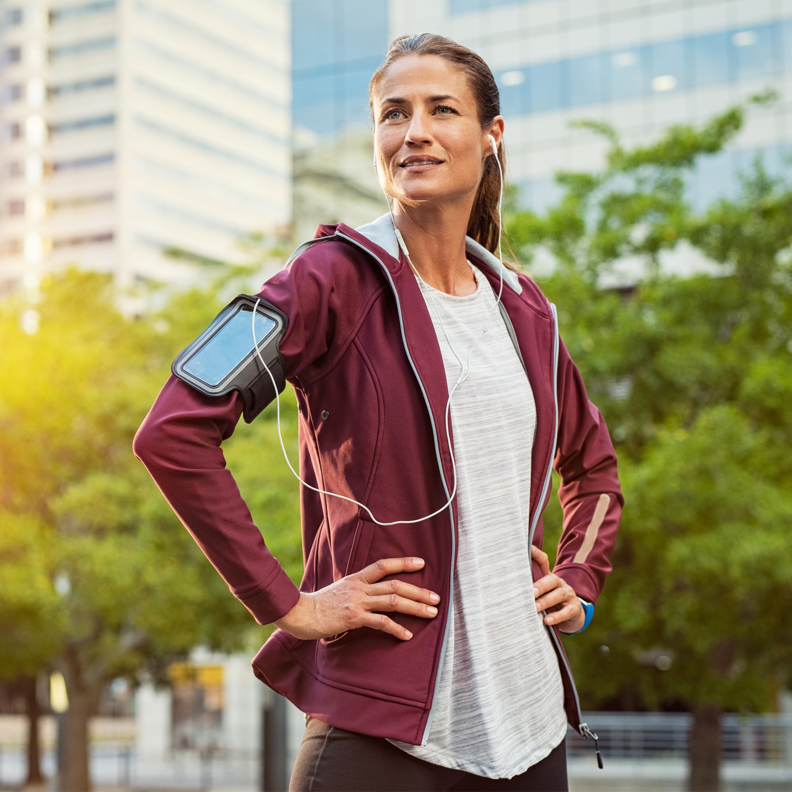 A sporty woman stands confidently.