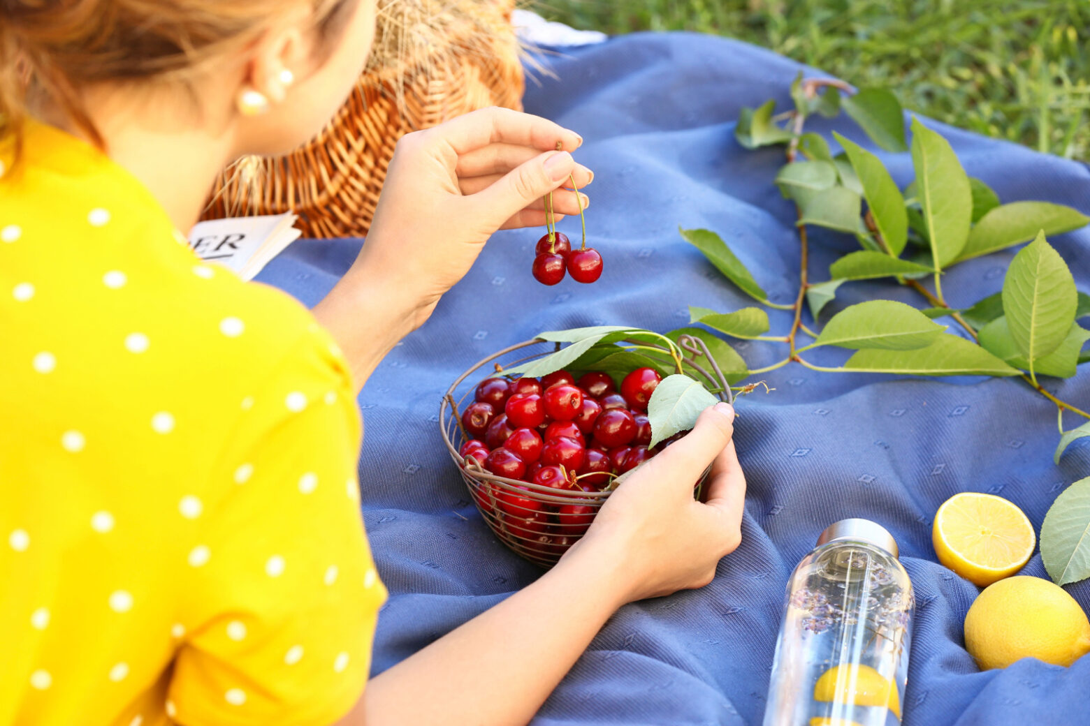 Woman eating a bowl of cherries