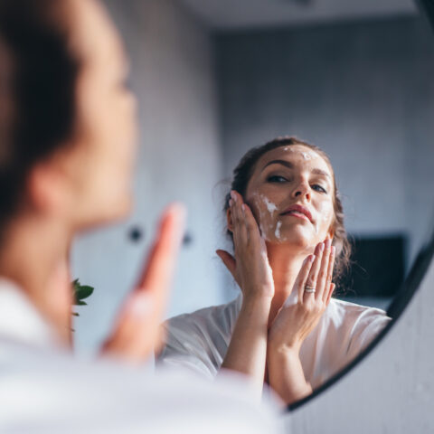 women washing her face in the sink