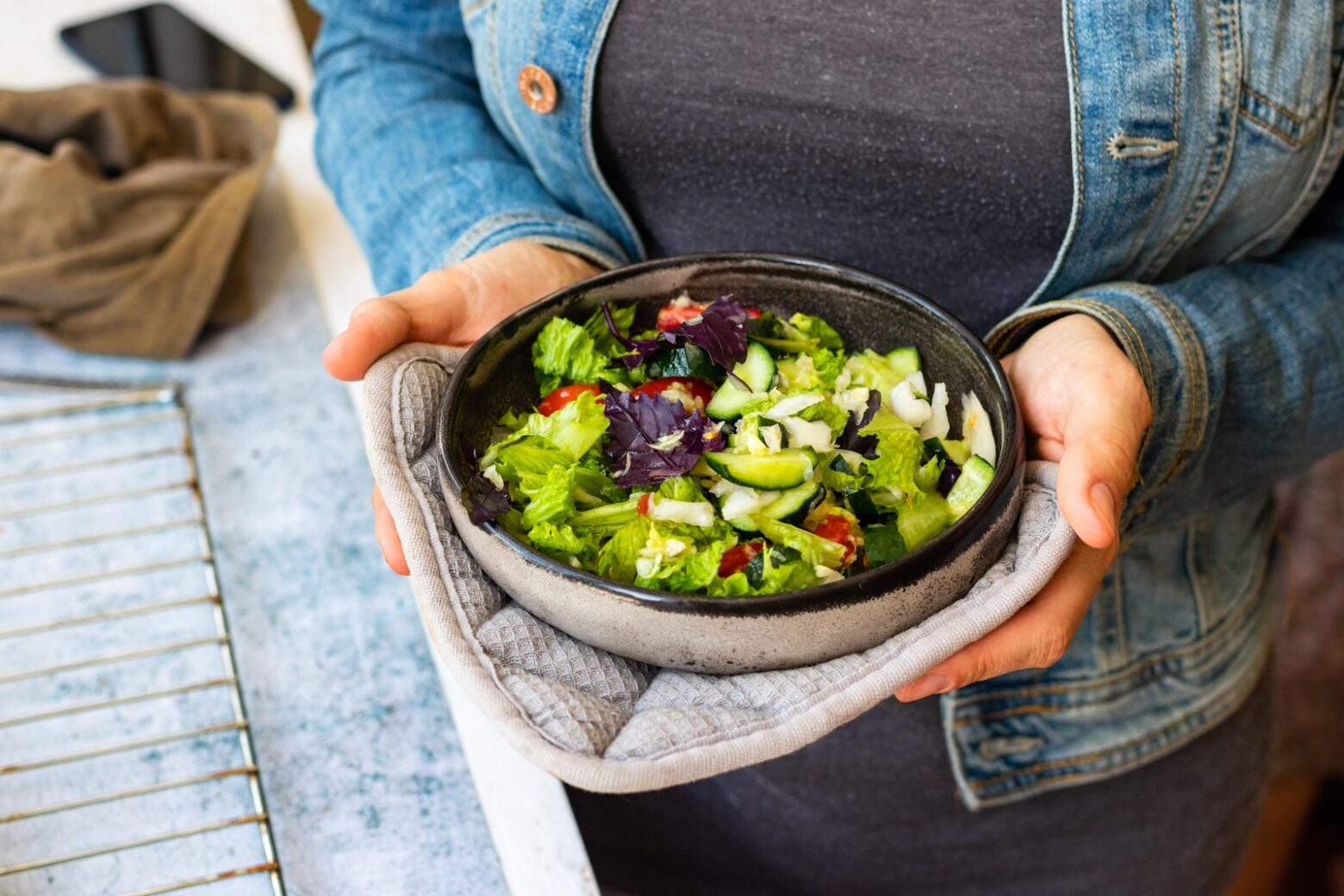 Close-up of a woman holding a Mediterranean Salad