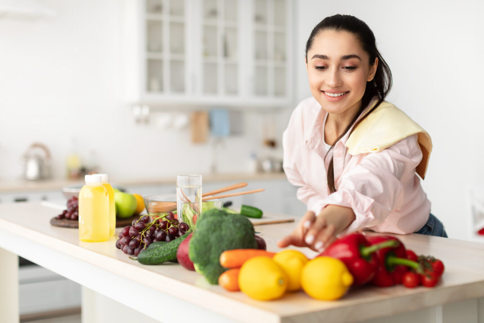 women reaching for vegetables